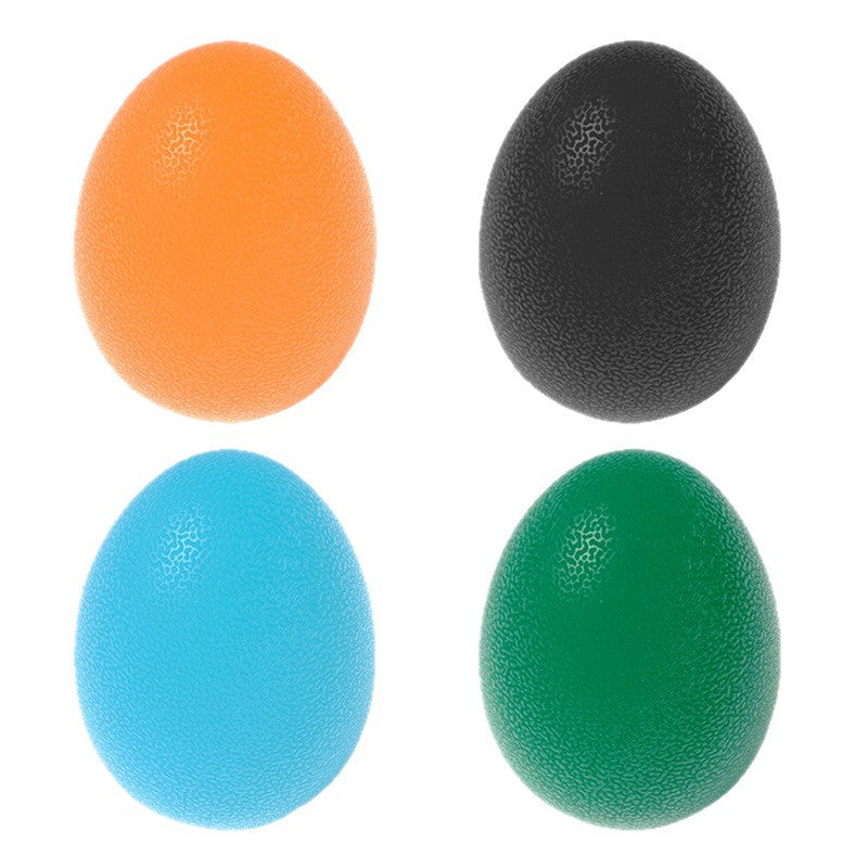 Colored textured training eggs in orange, black, blue, and green for fitness and rehabilitation exercises.
